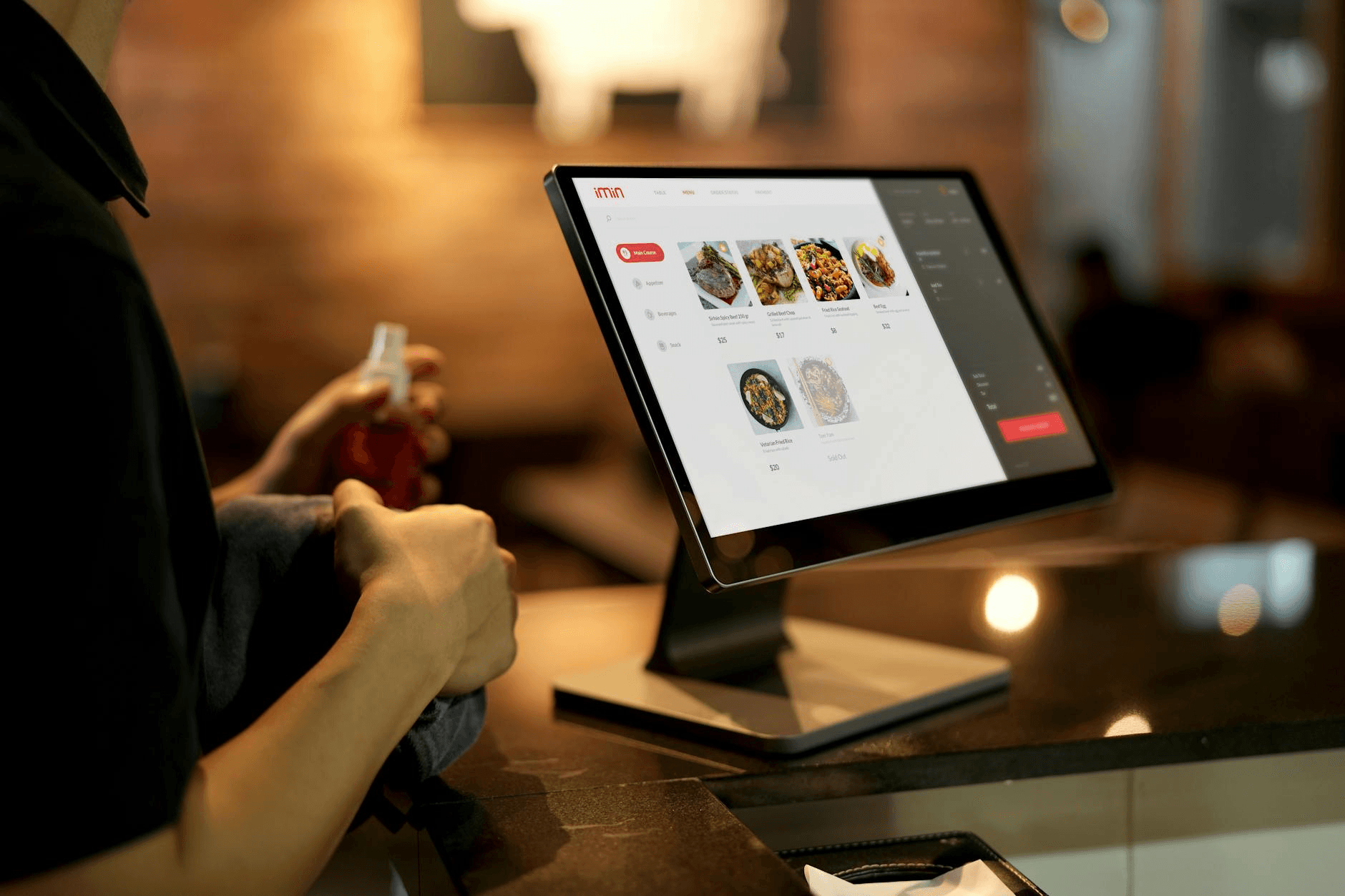 Restaurant manager reviewing POS dashboard on tablet - how to build an app like Toast